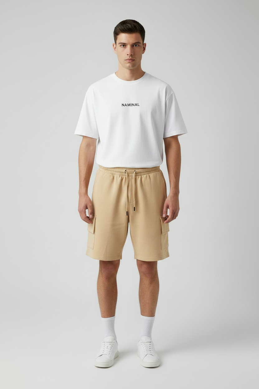 Man wearing a white t-shirt and beige shorts on a light gray background
