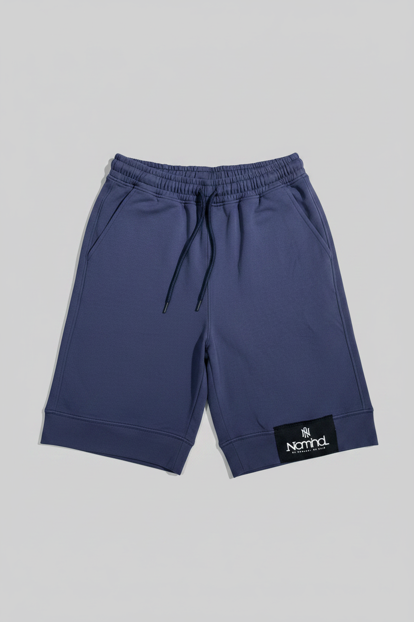 Navy blue shorts with a brand label on a gray background