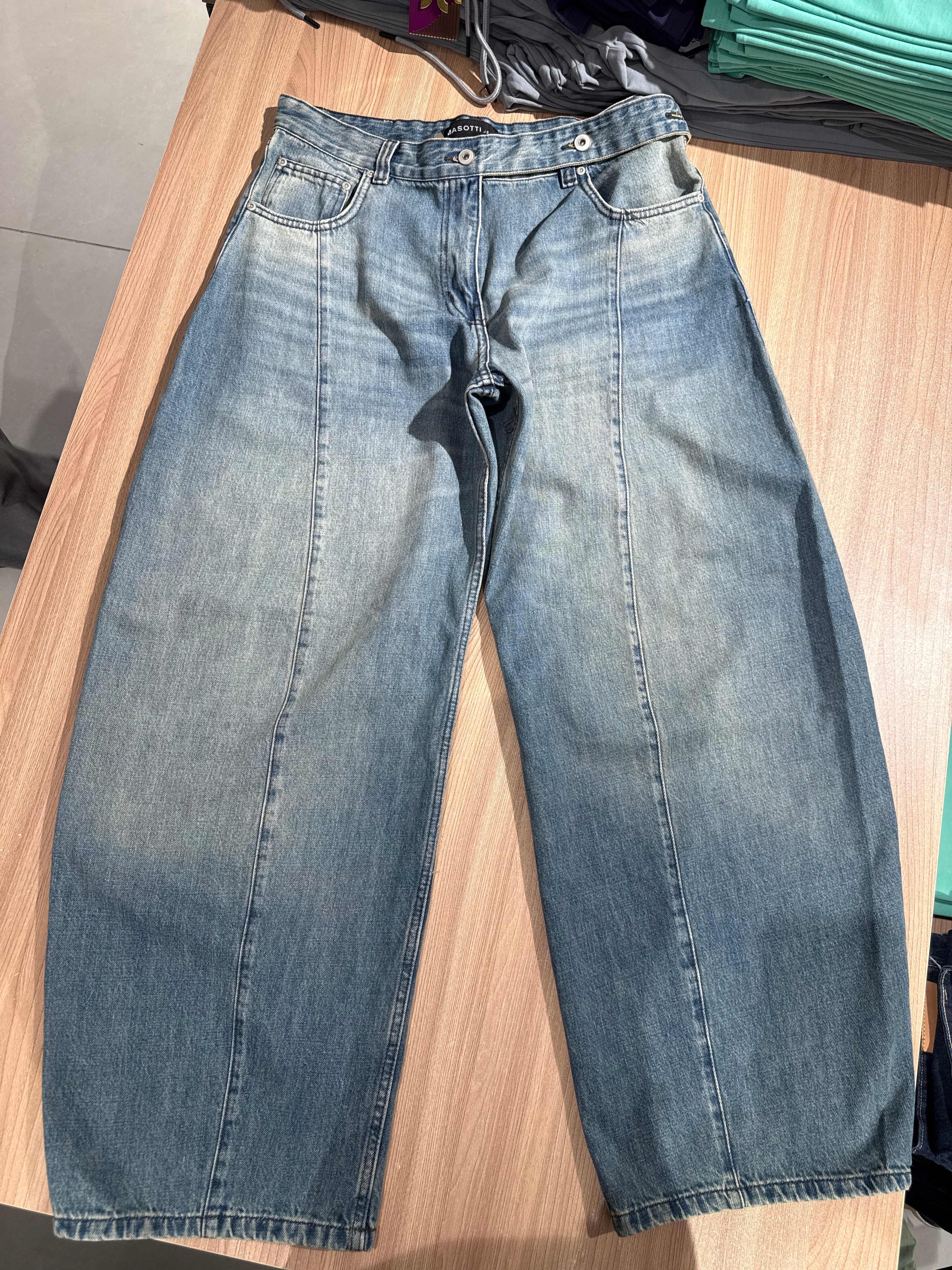 Pair of blue jeans on a wooden surface