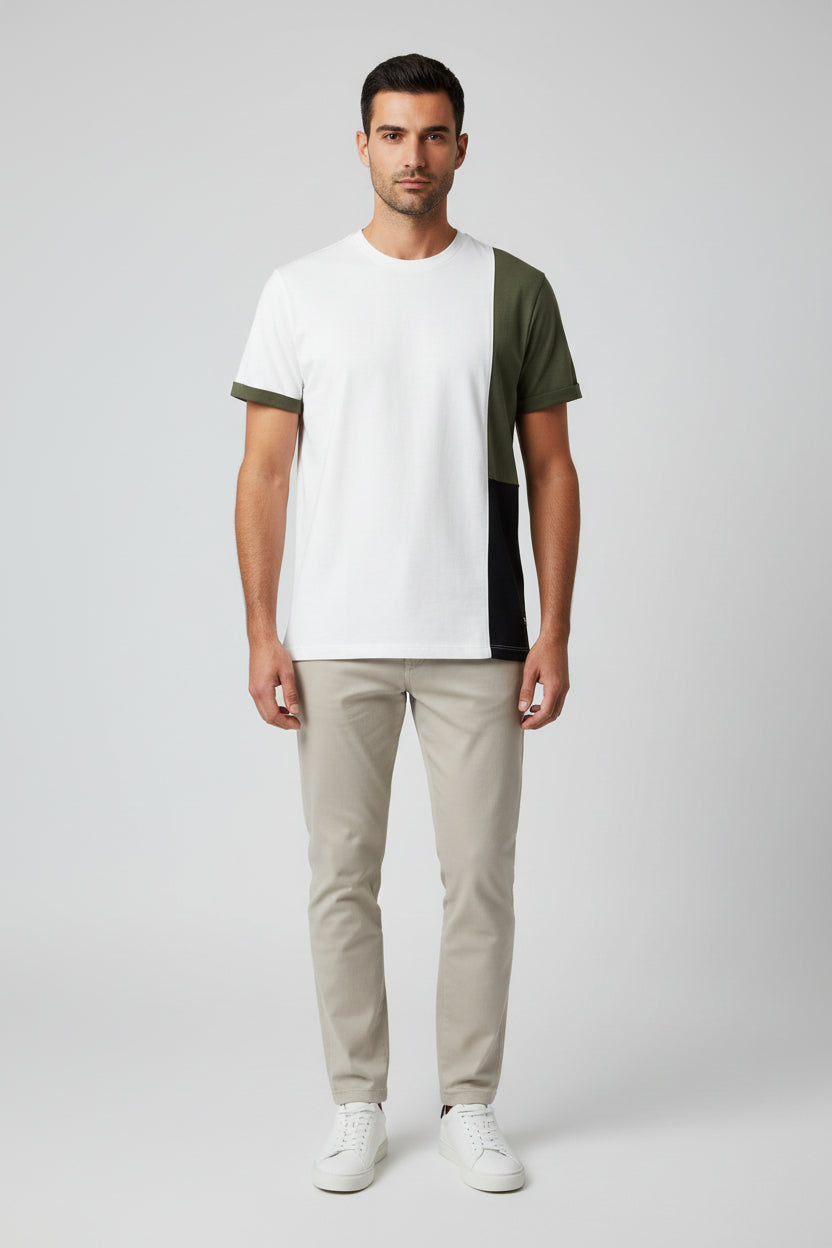 Color-blocked shirt with green, black, and white sections on a wooden surface