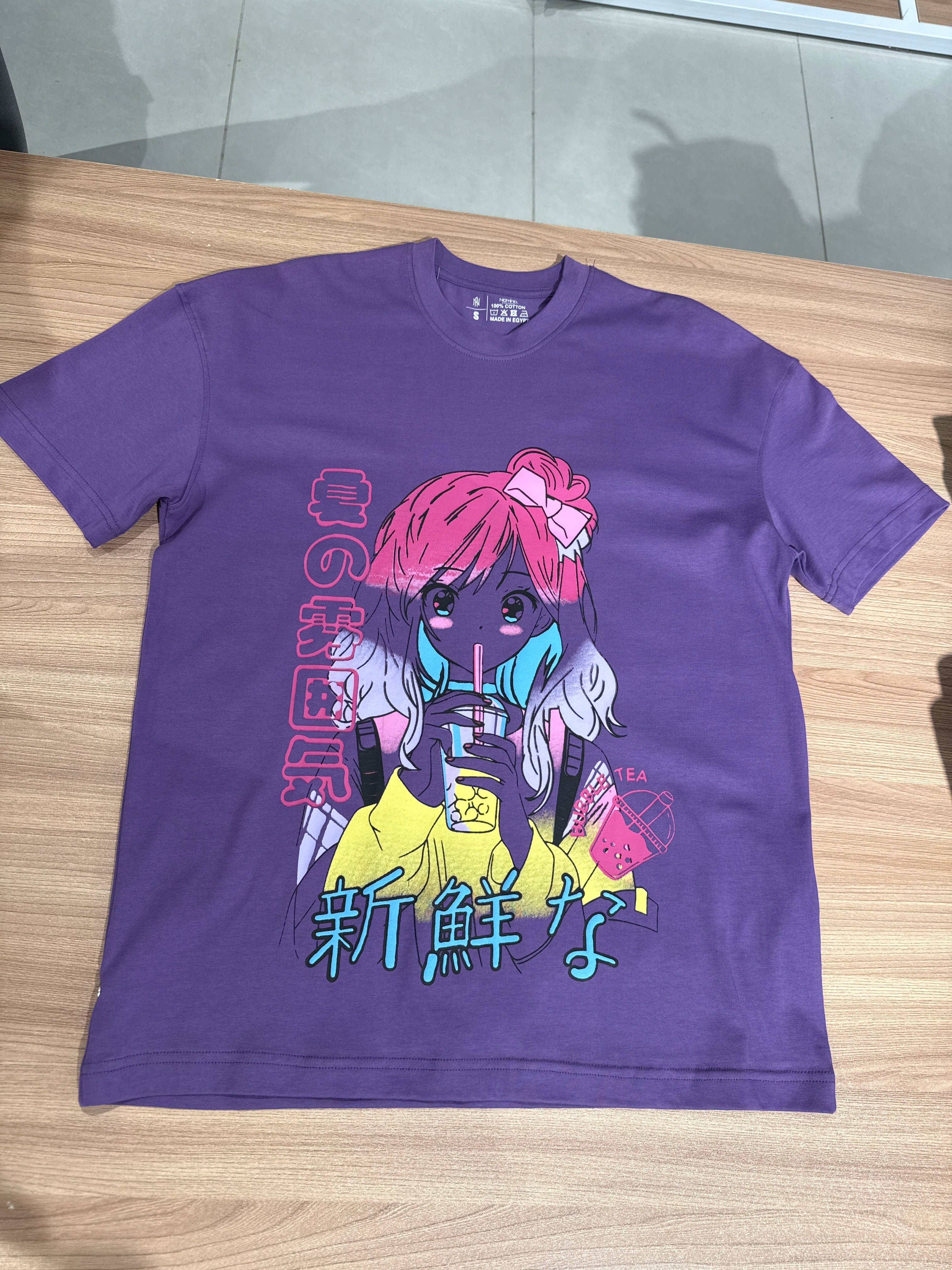 Purple t-shirt with colorful graphic design on a wooden surface